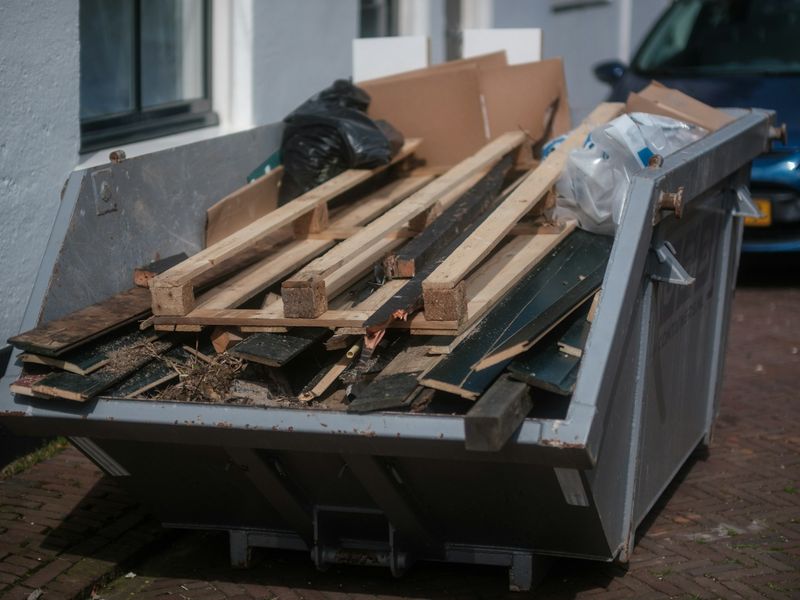 A skip loaded with timber and household clearance